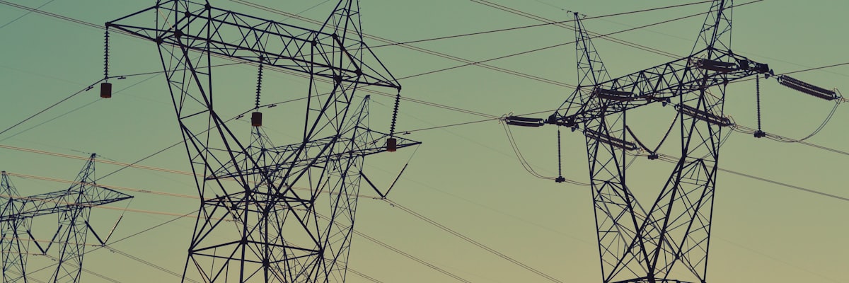 Power lines and transmission towers against an open sky