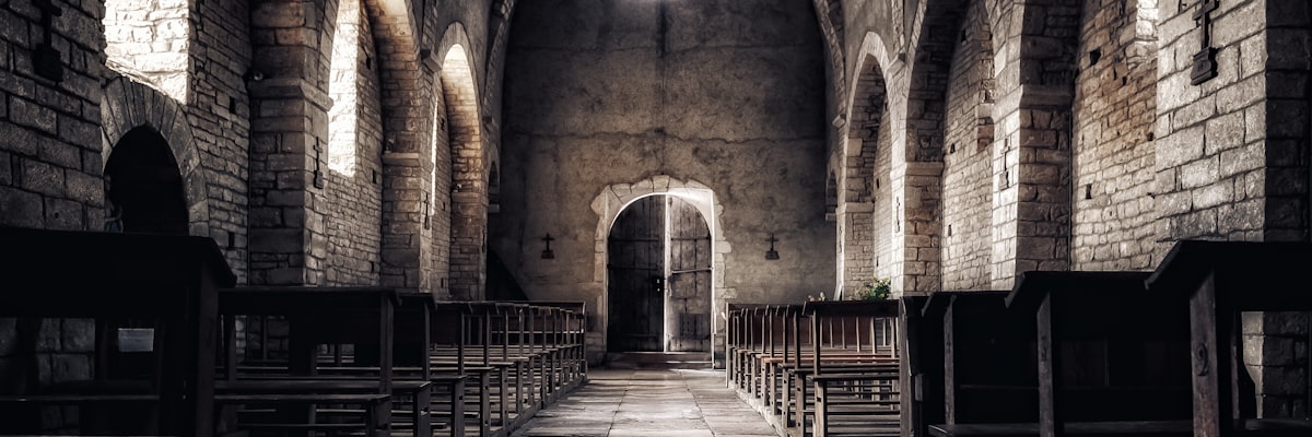 Interior of a stone church nave with natural light through windows